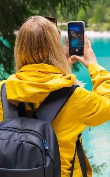 Traveler in yellow jacket using phone